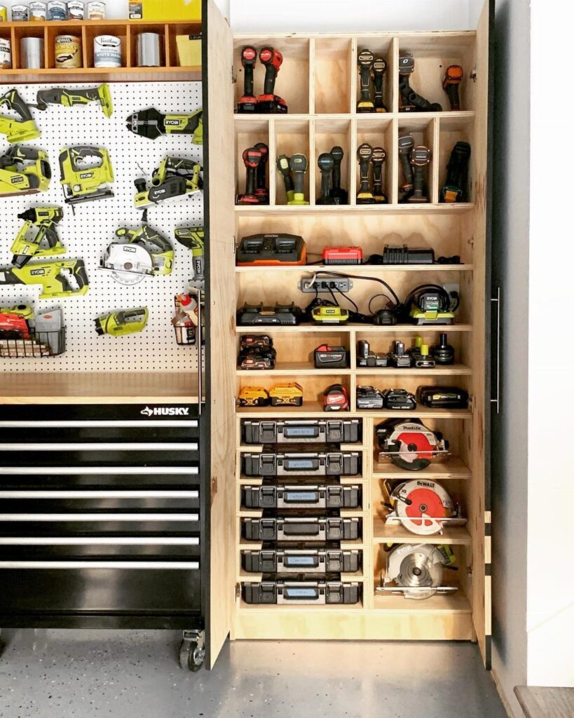 Wooden tool organizer cabinet and black tool chest filled with various power tools and accessories.